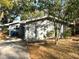 Charming single-story home featuring mature trees, side carport, and a classic design at 626 N Nashua Ave, Fort Meade, FL 33841
