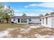 The backyard shows the exterior of the house, the back door and a shed at 6261 Red Grange Blvd, Indian Lake Estates, FL 33855