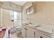 Neutral bathroom with a vanity sink, mirrored medicine cabinet, and shower with glass doors at 6261 Red Grange Blvd, Indian Lake Estates, FL 33855