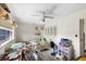 Bedroom featuring a ceiling fan, carpeted floor, window, and closet at 6261 Red Grange Blvd, Indian Lake Estates, FL 33855