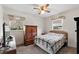 Bright bedroom features a ceiling fan and a window for natural light at 6261 Red Grange Blvd, Indian Lake Estates, FL 33855