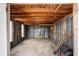 Open garage with exposed wood beams, metal siding, and concrete floors at 6261 Red Grange Blvd, Indian Lake Estates, FL 33855