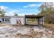 Practical shed and carport offering convenient storage and vehicle protection on the property at 6261 Red Grange Blvd, Indian Lake Estates, FL 33855
