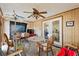 View of a sunroom with wood paneled walls, carpet, and furniture at 6261 Red Grange Blvd, Indian Lake Estates, FL 33855