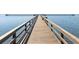 Picturesque wooden pier stretching out into the tranquil, inviting lake at 6261 Red Grange Blvd, Indian Lake Estates, FL 33855