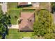 Aerial view showcasing the house, its roof, backyard and landscaping, providing a comprehensive property overview at 633 Hart Lake Dr, Winter Haven, FL 33884