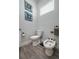 Bright bathroom features a toilet and bidet with wood-look flooring and decorative wall art at 633 Hart Lake Dr, Winter Haven, FL 33884