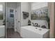 Luxurious bathroom with a modern soaking tub, stylish fixtures, and sleek design elements for a spa-like experience at 633 Hart Lake Dr, Winter Haven, FL 33884