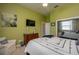 Relaxing bedroom featuring muted green walls, carpet flooring, and a modern television for ultimate convenience at 633 Hart Lake Dr, Winter Haven, FL 33884