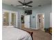 Spacious main bedroom featuring french doors, a walk-in closet and ceiling fan for added comfort at 633 Hart Lake Dr, Winter Haven, FL 33884