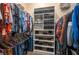 Organized walk-in closet with shelving for shoes, handbags, and hanging clothes at 633 Hart Lake Dr, Winter Haven, FL 33884