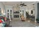 Bright living room with a cozy fireplace, neutral decor, and open access to the dining and kitchen areas at 633 Hart Lake Dr, Winter Haven, FL 33884