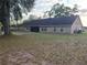 Wide backyard view with a brick patio, lawn and access to the home at 700 E Park Rd, Haines City, FL 33844