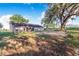 Large backyard featuring mature trees, a brick patio, and room for recreation at 700 E Park Rd, Haines City, FL 33844