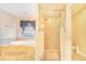 Spa-like bathroom with soaking tub, glass shower, and neutral color scheme at 700 E Park Rd, Haines City, FL 33844