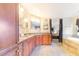 Spacious bathroom with double sinks, granite countertops, wooden cabinetry, and tub at 700 E Park Rd, Haines City, FL 33844