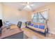 Cozy bedroom with a futon, desk area and natural light from the large window at 700 E Park Rd, Haines City, FL 33844