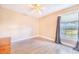 Bright bedroom with wood-look tile flooring, ceiling fan, and natural light from window at 700 E Park Rd, Haines City, FL 33844