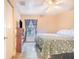Cozy bedroom with a ceiling fan, wood-look floors, and a window with curtains at 700 E Park Rd, Haines City, FL 33844