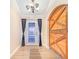 Elegant foyer features wood-look flooring and striking wooden accent door at 700 E Park Rd, Haines City, FL 33844