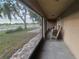 Covered front porch with rocking chairs and a view of the yard and neighborhood at 700 E Park Rd, Haines City, FL 33844