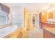 Relaxing main bathroom with soaking tub, walk-in shower, and dual vanities at 700 E Park Rd, Haines City, FL 33844