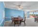 Bright dining room features a ceiling fan, a view to the exterior and a wooden table set for four at 700 Mirror Ter Nw # 501, Winter Haven, FL 33881