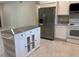 Kitchen featuring an island, white cabinets, and stainless steel appliances at 708 E Broadway St, Fort Meade, FL 33841