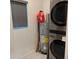 Laundry room with stacked washer and dryer and tank water heater at 708 E Broadway St, Fort Meade, FL 33841