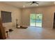 Expansive living room featuring tile floors, a ceiling fan, and sliding doors to the backyard at 708 E Broadway St, Fort Meade, FL 33841