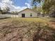 Backyard features a lawn with some patchy areas and a fenced perimeter for privacy at 847 Kristen Ct, Bartow, FL 33830