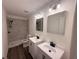 Well-lit bathroom features dual sinks, modern fixtures, and a tiled shower with a glass door at 847 Kristen Ct, Bartow, FL 33830