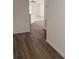 Interior view of a hallway with new wood-look flooring leading to a bright, open living space at 847 Kristen Ct, Bartow, FL 33830
