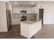 Modern kitchen features stainless steel appliances, granite countertops, and an island with a sink at 847 Kristen Ct, Bartow, FL 33830