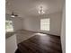 Bright and airy living room with new flooring, large windows, and modern lighting fixtures at 847 Kristen Ct, Bartow, FL 33830