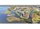 Aerial view of townhomes nestled on a lake with water access and lush landscaping at 900 Avenue Z Se # A3, Winter Haven, FL 33880