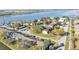 Aerial view showcases lakefront townhome community with mature trees and well-kept grounds at 900 Avenue Z Se # A3, Winter Haven, FL 33880