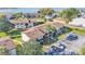 Aerial view of the building with palm trees, parking, and a glimpse of the lake in the background at 900 Avenue Z Se # A3, Winter Haven, FL 33880