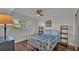 Simple bedroom featuring a white metal bedframe, modern ceiling fan, and dark wood flooring at 900 Avenue Z Se # A3, Winter Haven, FL 33880