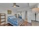 Bedroom view showing white metal bedframe, modern ceiling fan, and sliding mirror closet door at 900 Avenue Z Se # A3, Winter Haven, FL 33880