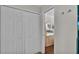 Bedroom view showing mirrored dresser beyond an open door and a large, white closet at 900 Avenue Z Se # A3, Winter Haven, FL 33880