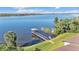 Waterfront view of a wooden dock with a gazebo on a large lake with a blue sky background at 900 Avenue Z Se # A3, Winter Haven, FL 33880