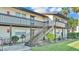 Exterior shot of a two-story building with well maintained landscaping and stairs leading to the second floor at 900 Avenue Z Se # A3, Winter Haven, FL 33880