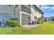 Exterior of a townhome with sliding doors and a private patio surrounded by green space at 900 Avenue Z Se # A3, Winter Haven, FL 33880
