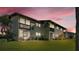 Townhome exterior with balconies, windows, lush lawn, and easy access to outdoor living at 900 Avenue Z Se # A3, Winter Haven, FL 33880