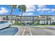 Exterior shot of a two-story building with parking, palm trees and stairs leading to the second floor at 900 Avenue Z Se # A3, Winter Haven, FL 33880