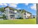 Townhome exterior with balconies, windows, lush lawn, and easy access to outdoor living at 900 Avenue Z Se # A3, Winter Haven, FL 33880