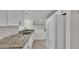 Bright kitchen with white cabinets, granite countertops, and modern faucet at 900 Avenue Z Se # A3, Winter Haven, FL 33880