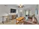 Open-concept living area with tile floors and access to outdoor patio at 900 Avenue Z Se # A3, Winter Haven, FL 33880