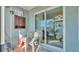 Enclosed patio with view through sliding glass doors and two white metal chairs at 900 Avenue Z Se # A3, Winter Haven, FL 33880